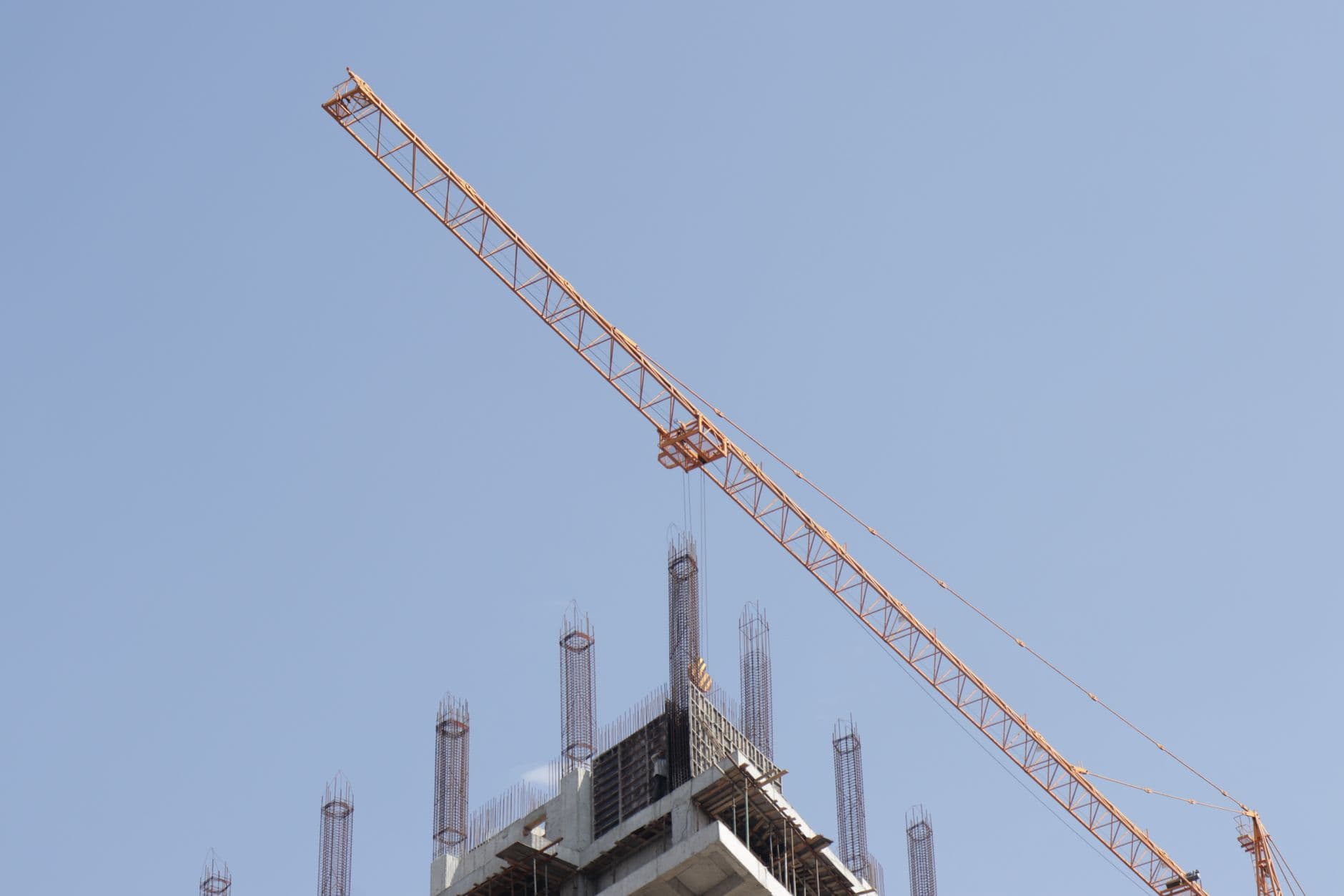 A tower crane over a high-rise construction site.